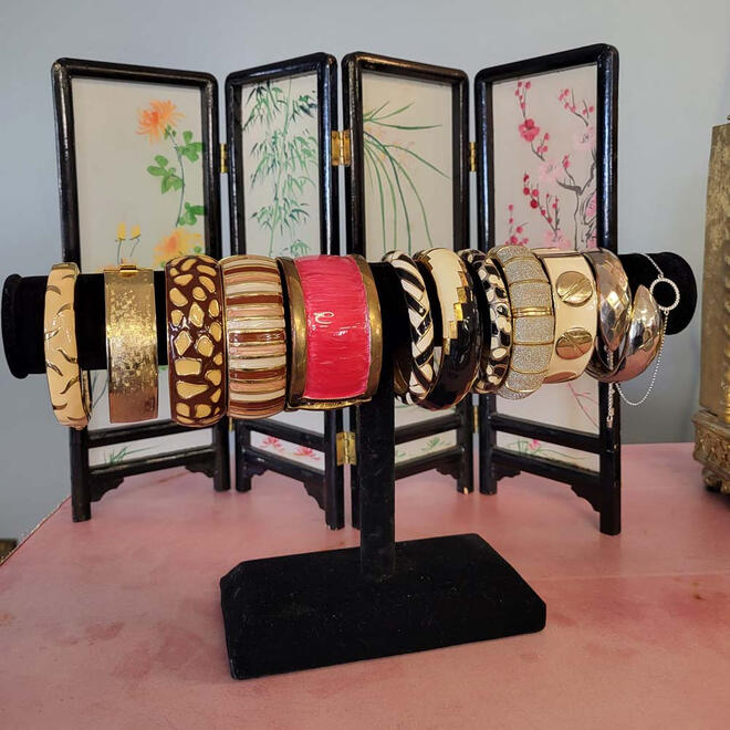 12 bracelets and bangles hanging on a velvet display