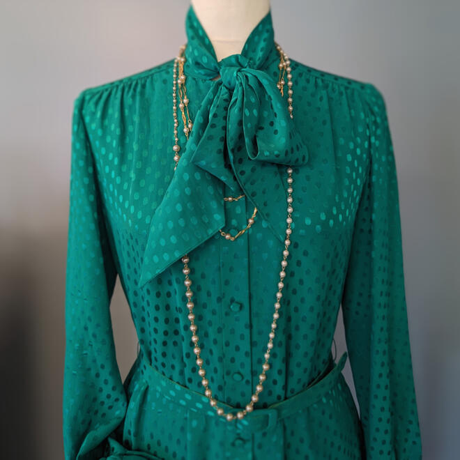 Vintage Nat Kaplan Couture dress in teal with asymmetrical glass pearls and gold tone and pearl necklaces.