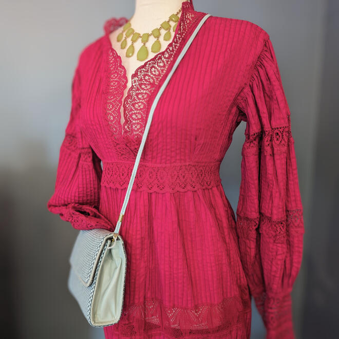 Pink Import Co dress with green costume jewelry necklace and Whiting and Davis International blue geometric purse.