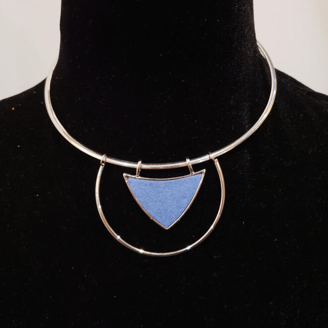 Vintage silver tone statement necklace with blue triangle accent.